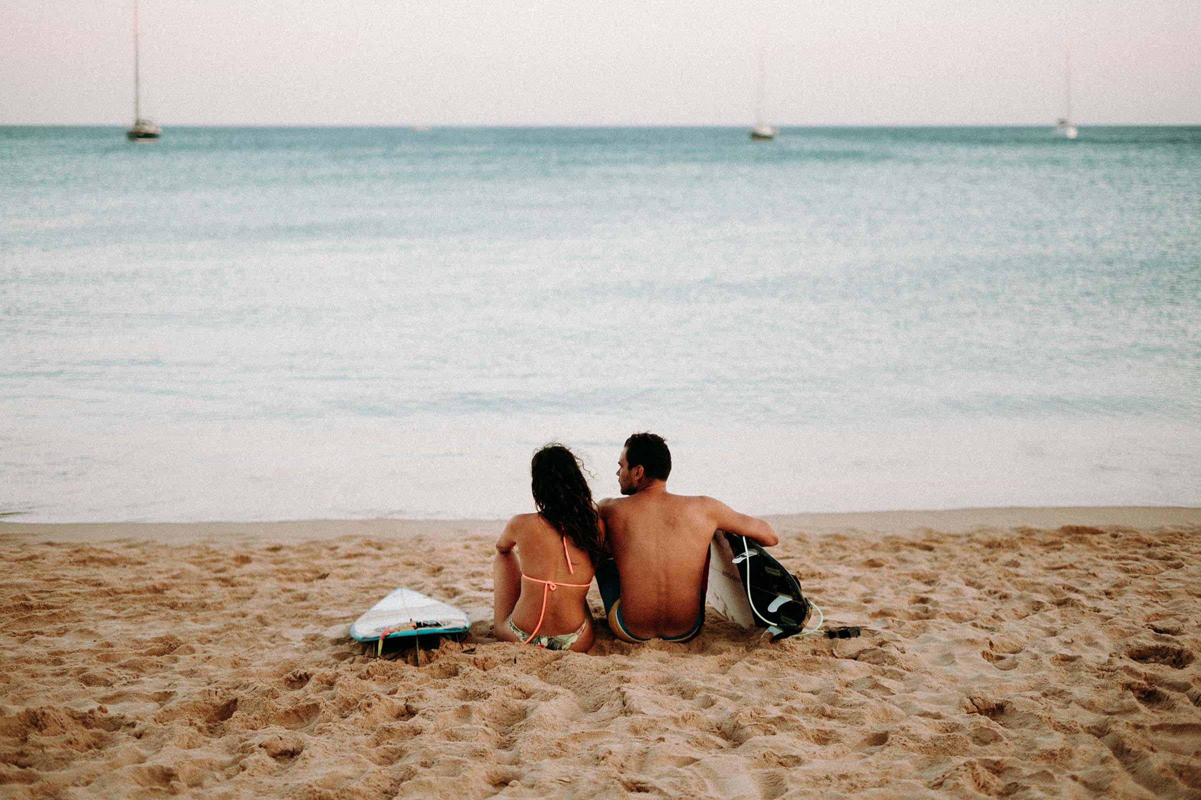 couple sitting in the beach by the sea