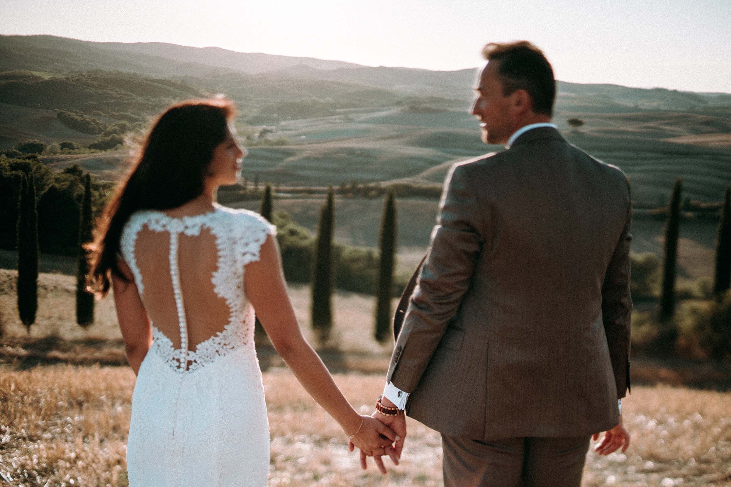 couple holding hands out of focus in foreground